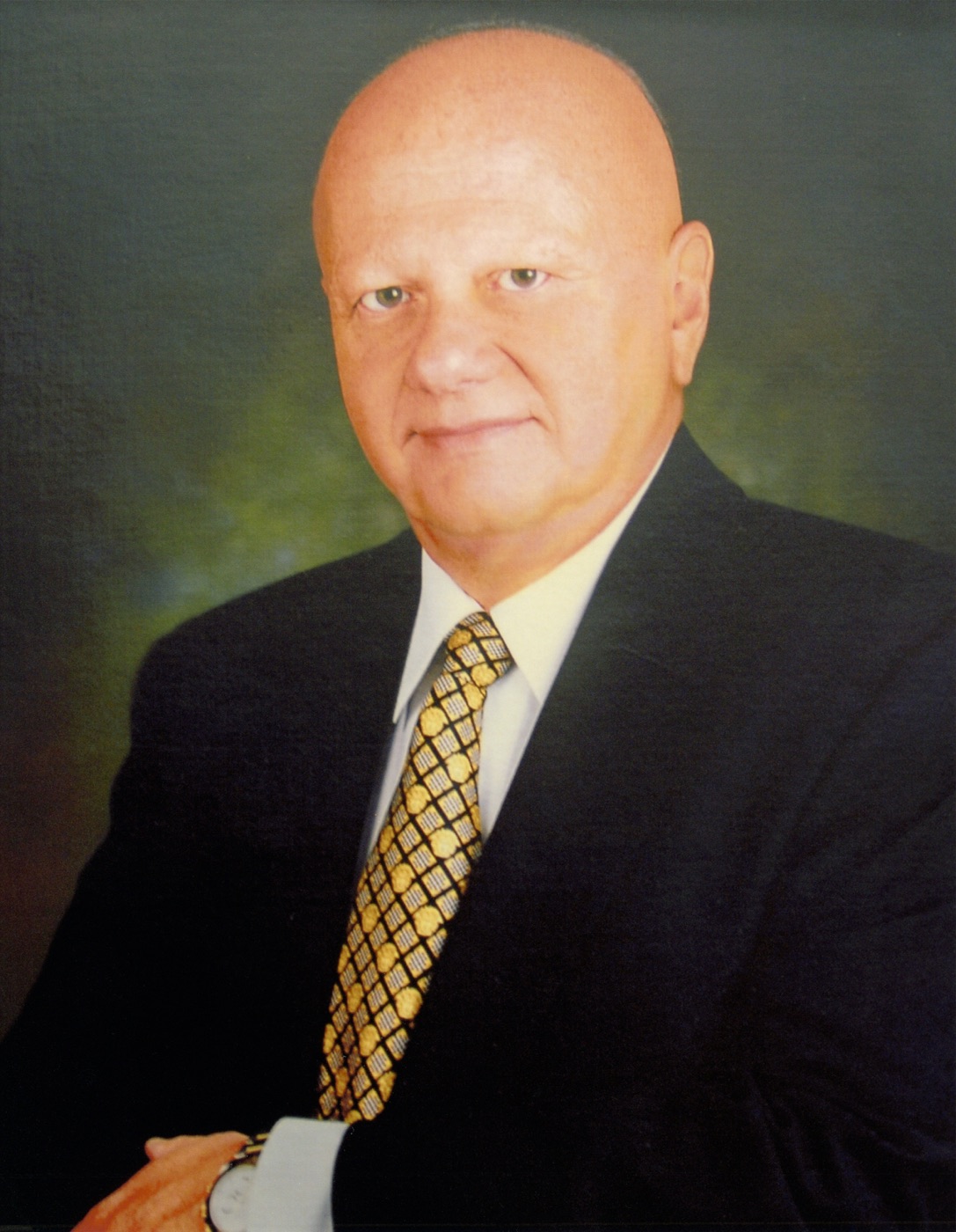 Marvin H. Weiner in a dark suit and patterned gold tie